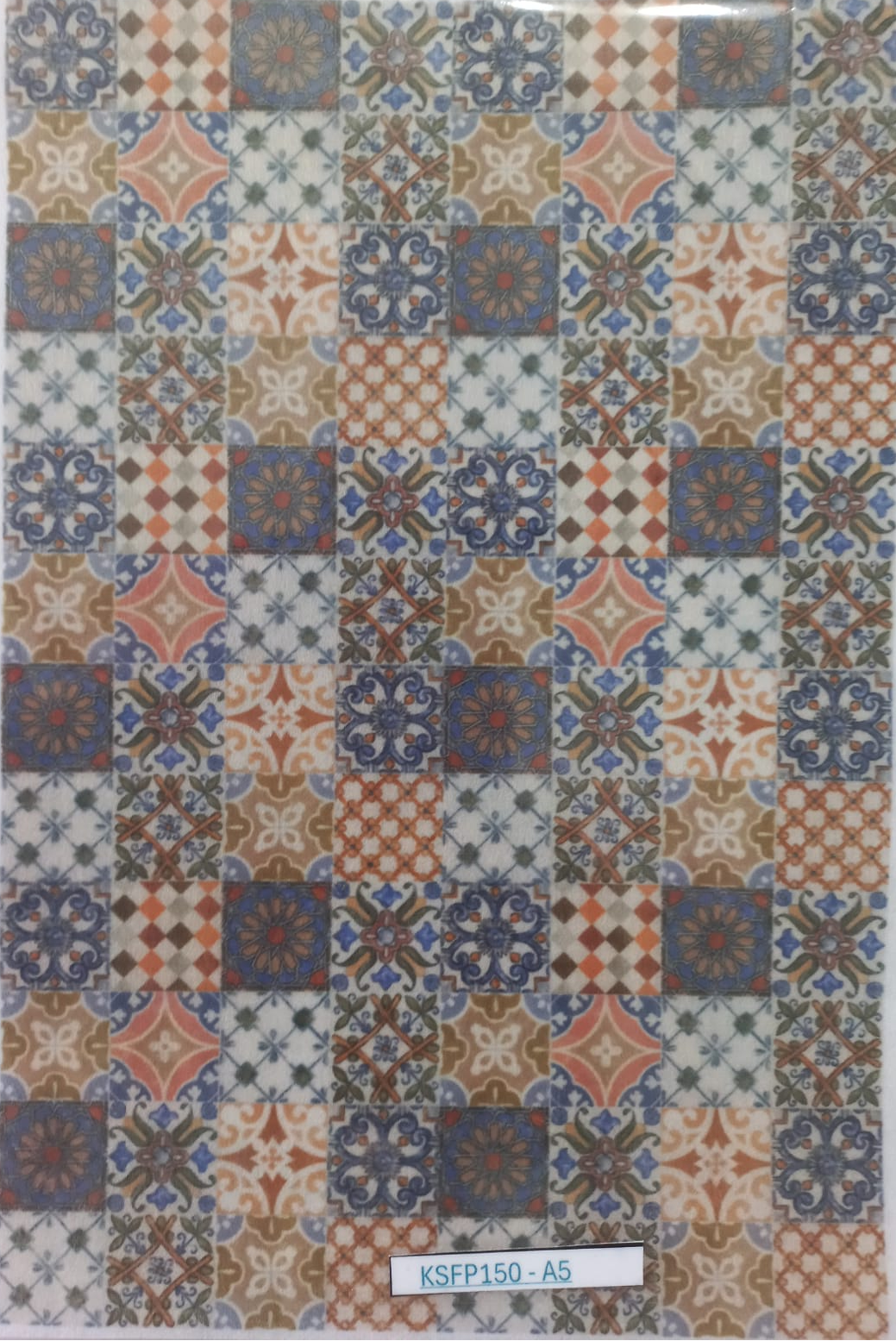 A sheet of decorative patterned tiles with a patchwork design in blue, terracotta, beige, and white, enclosed in a clear plastic sleeve with a label at the bottom reading KSFP150-A5.