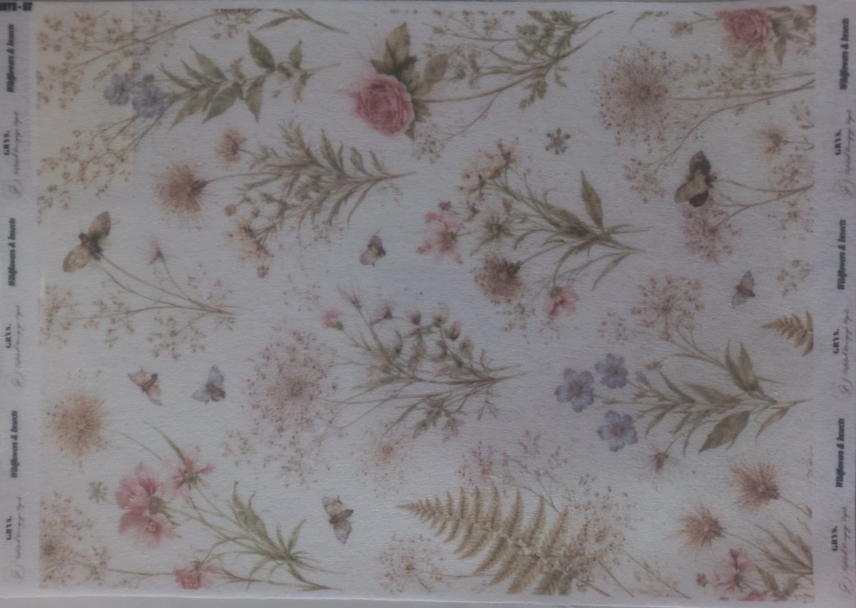 A sheet of decorative paper featuring a vintage-style floral and butterfly pattern in muted pink, green, and beige tones, photographed inside a clear plastic sleeve.