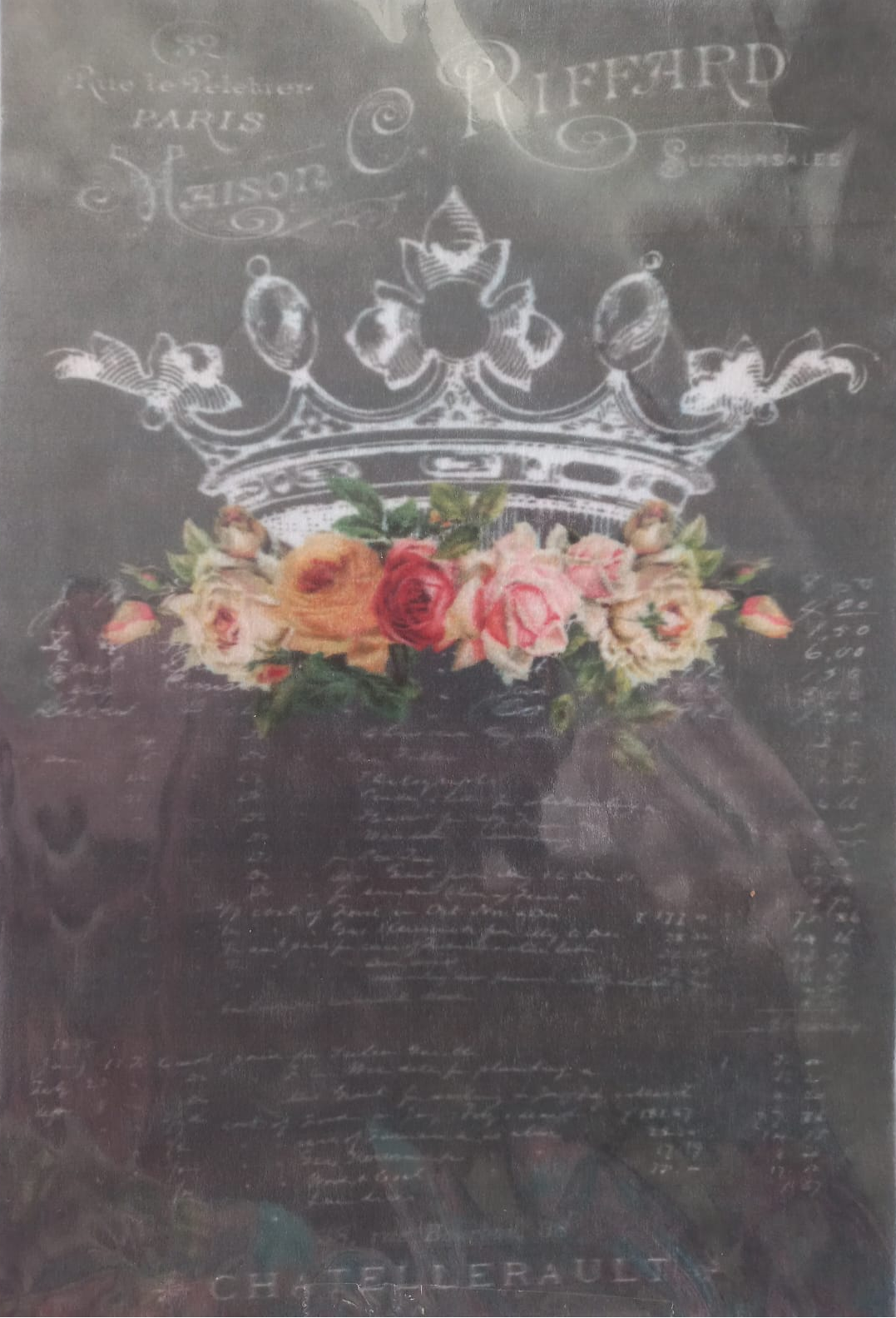 A vintage-style printed cloth or sign featuring a large white crown, pink and peach flowers, and cursive French text on a dark background.