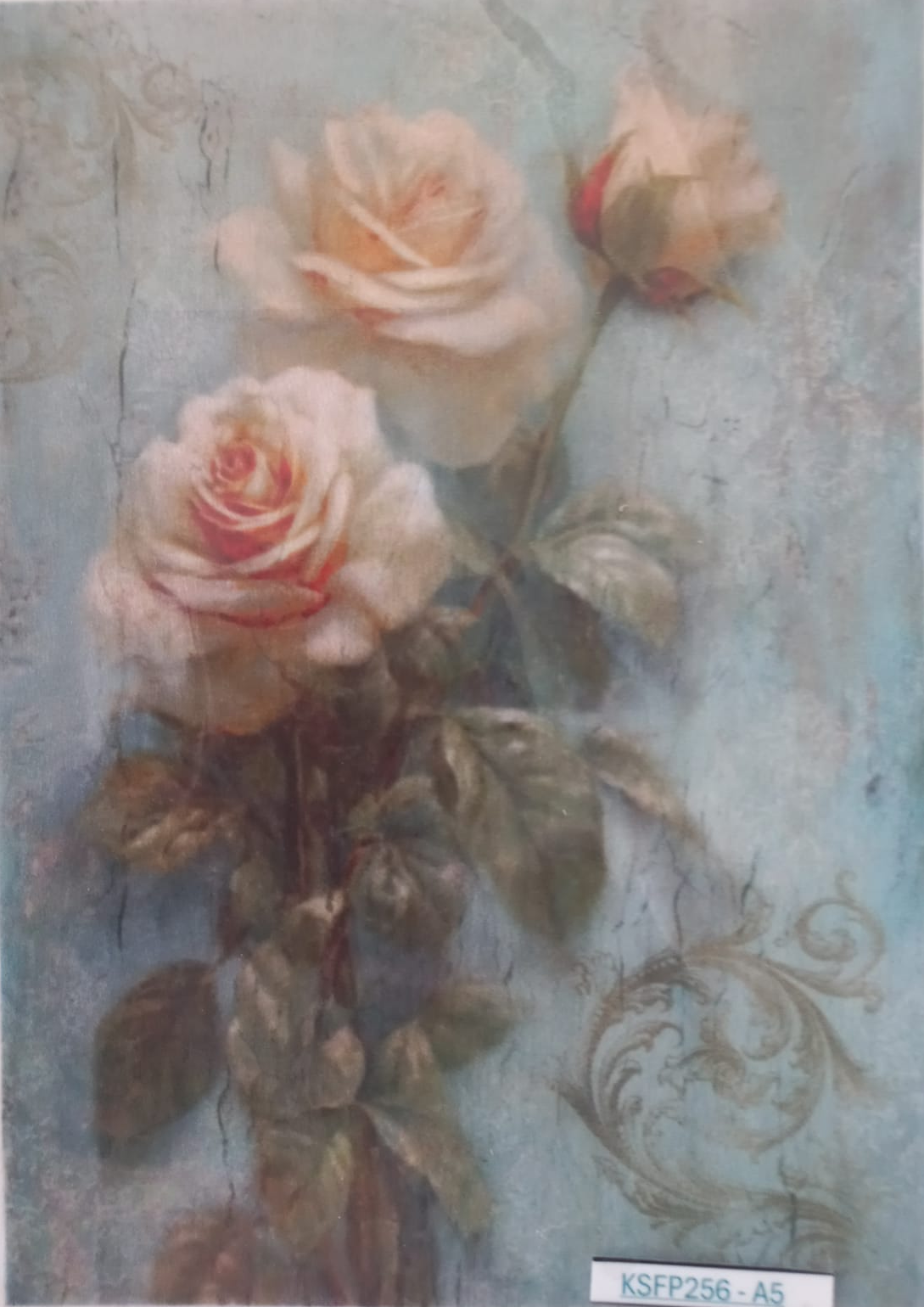 A vintage-style floral art print featuring cream and pink roses with green leaves on a distressed light blue background, shown flat with a small white label on the left side.