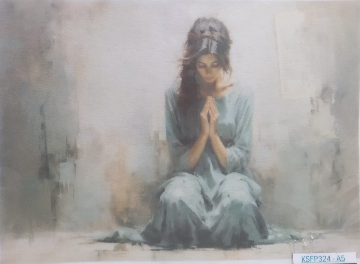 A religious art print depicting a woman in a blue-gray robe kneeling and praying with her hands together, set against a soft, textured gray and beige background. The print has a white border and a code label 'KSFP324-A5' in the bottom right corner.