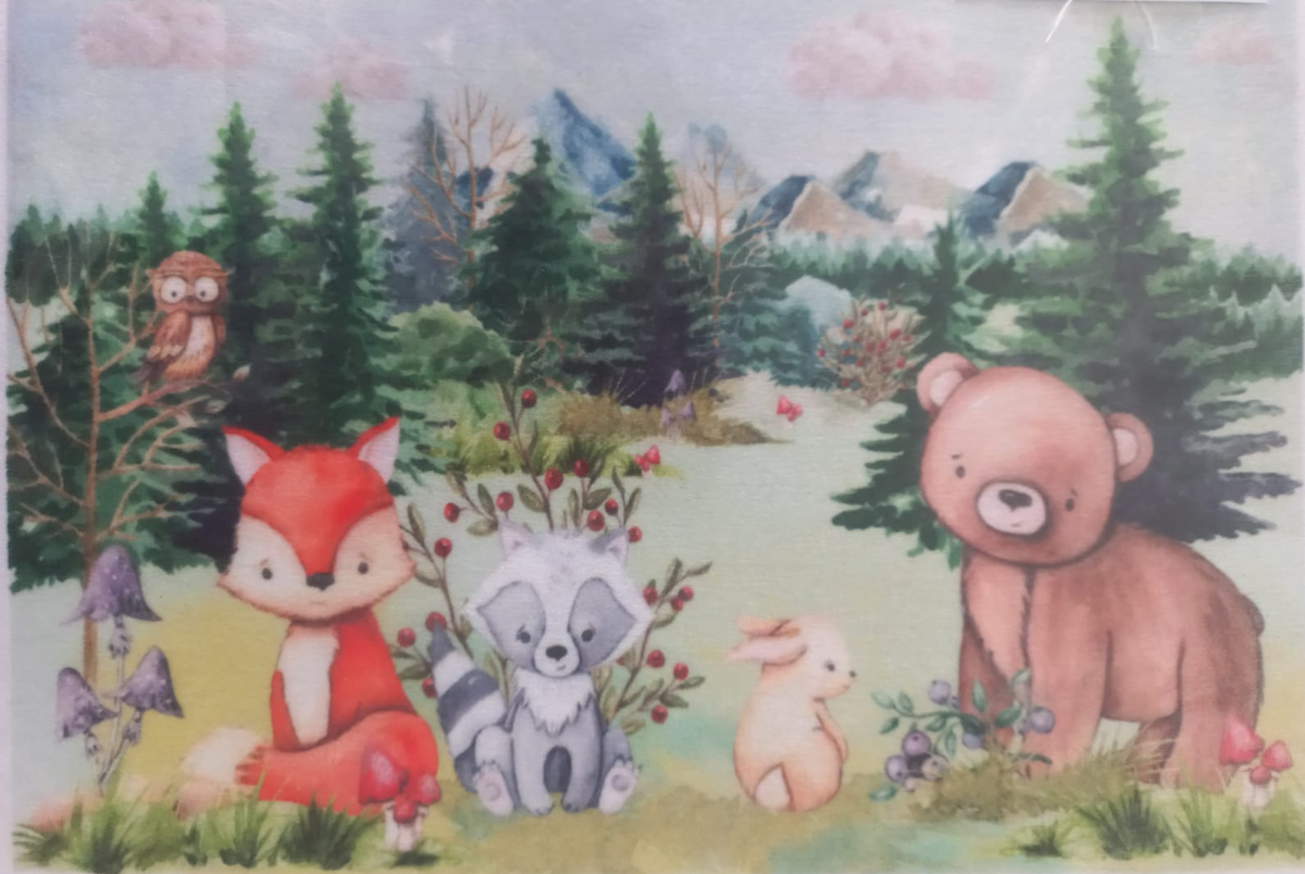 A colorful children's watercolor-style forest illustration featuring a fox, raccoon, bear, rabbit, owl, mushrooms, trees, and mountains. The artwork fills most of the frame, with a white border and a small printed label in the top right corner.