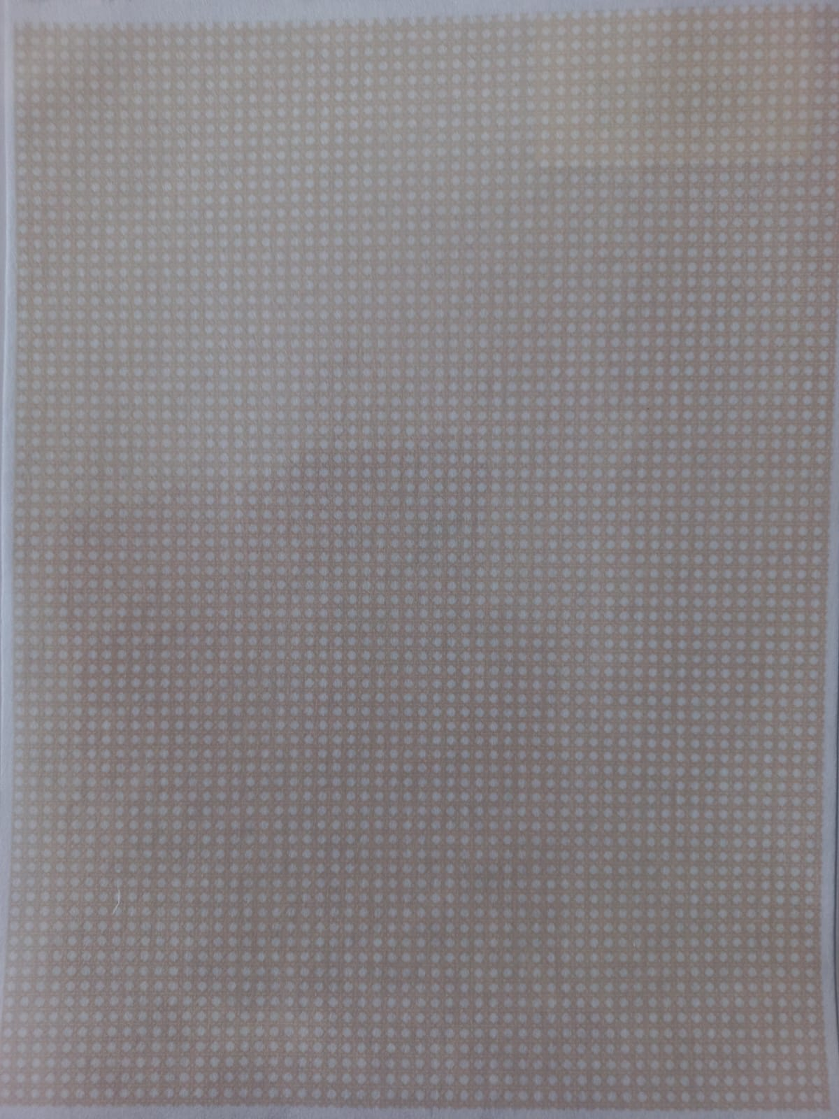 A square sheet of fabric or paper featuring a small, repeating beige and white polka dot pattern.