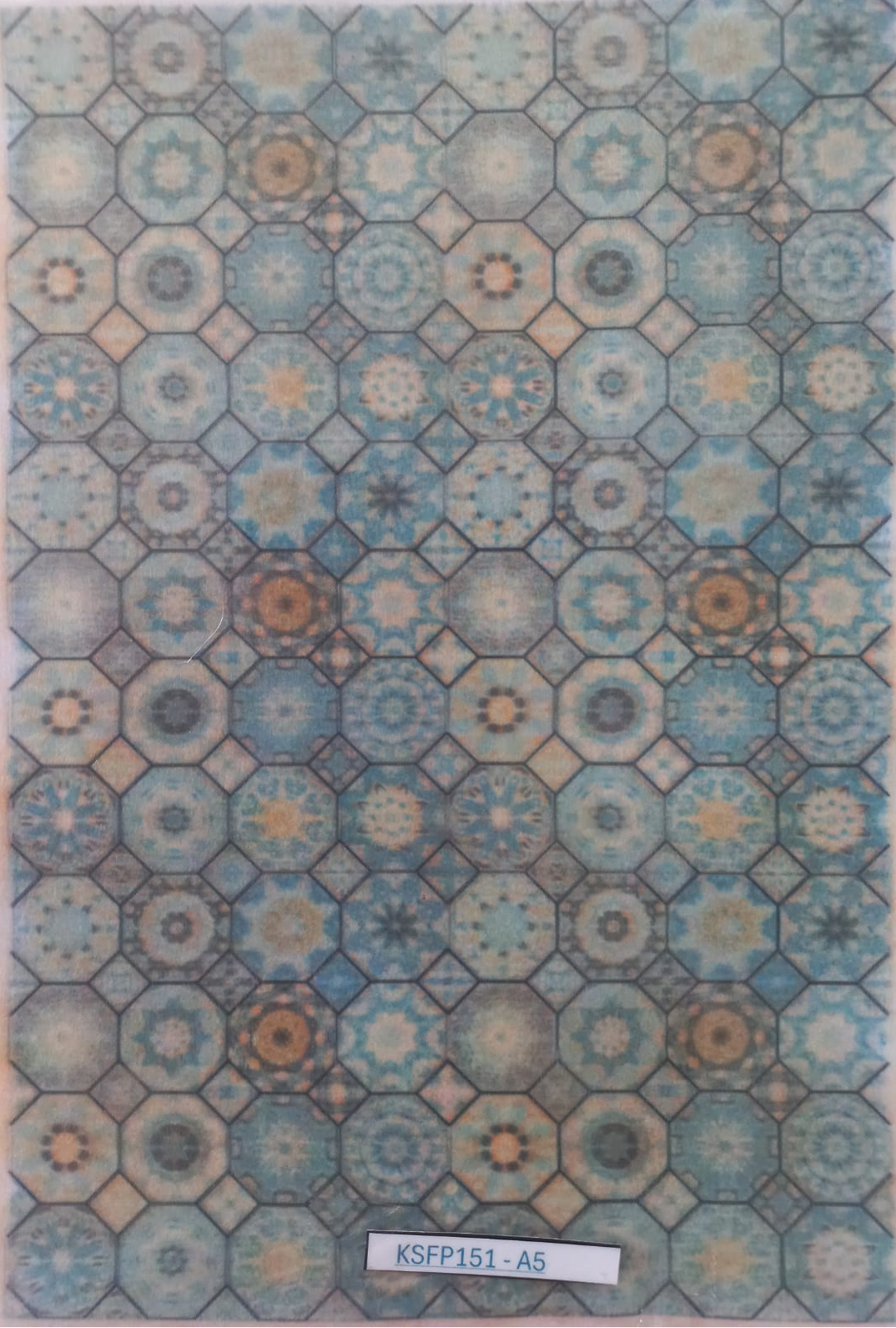 A square sample of a geometric patterned material or wallpaper featuring a repeating octagonal and starburst motif in shades of blue, beige, and gray, with a white label at the bottom reading 'KSFP151-A5'.