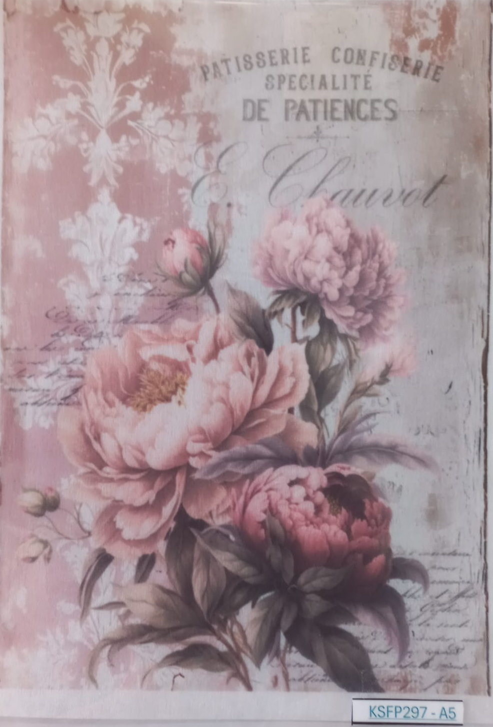 A rectangular decorative print or card featuring a vintage-style floral design with large pink peonies, botanical motifs, and French text including 'PATISBERGIE CONFISERIE DE PATIENS & Chaulrot'. The print is photographed inside a clear plastic sleeve against a white background.