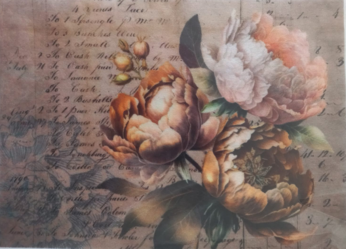 A square decorative card or print featuring three large peony flowers in warm peach, orange, and cream tones over a vintage script background, photographed inside a clear plastic sleeve.