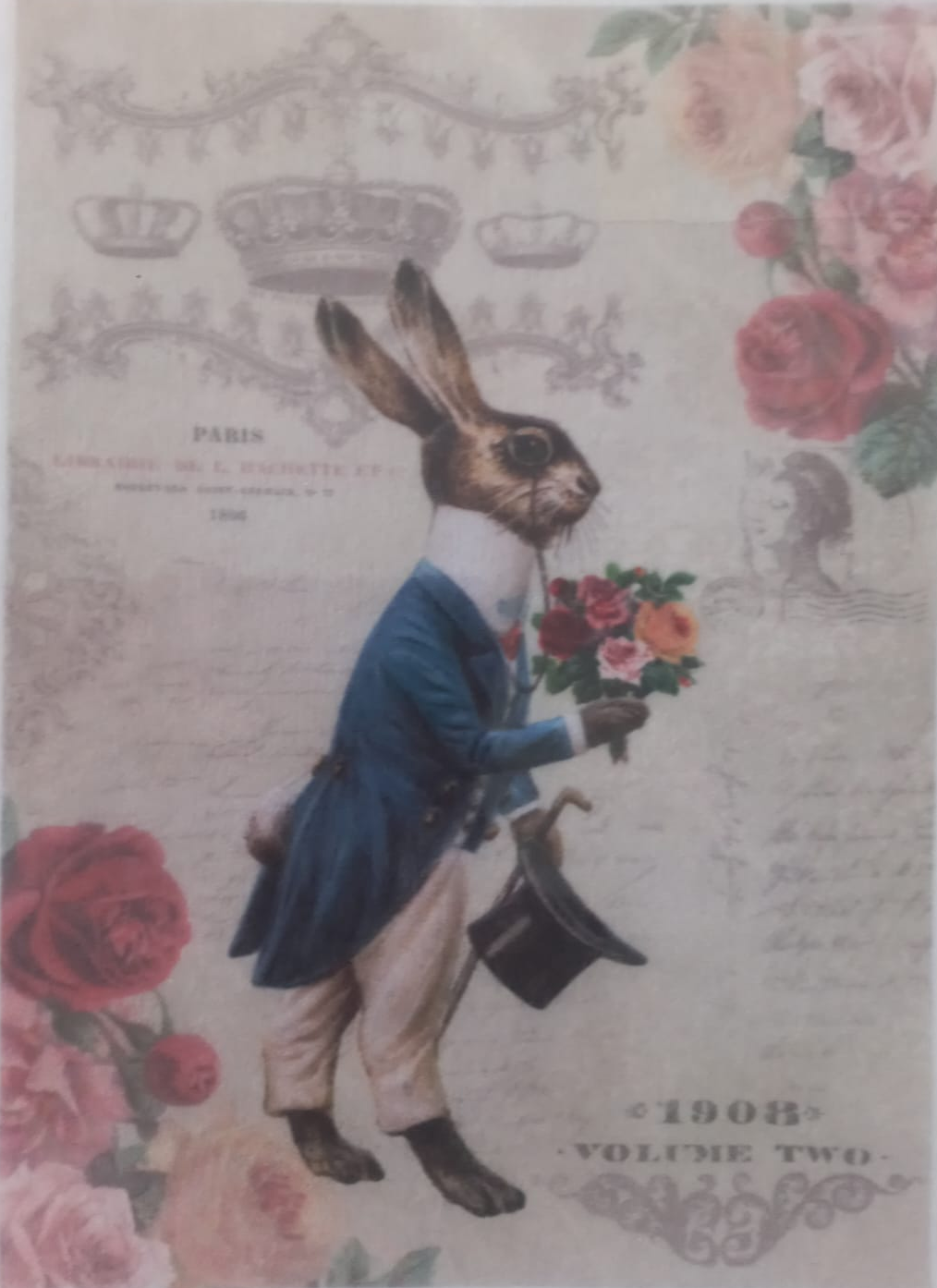 A vintage-style illustrated rabbit dressed in a blue coat, beige trousers, and holding a bouquet of flowers, with roses and ornate decorative elements around the border. The artwork appears to be printed on a card or sticker and is photographed inside a clear plastic sleeve.