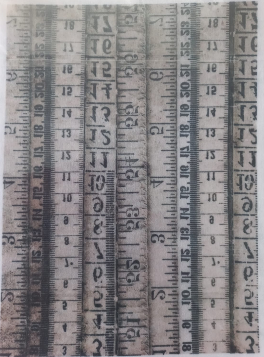 A rectangular printed design featuring multiple vertical vintage tape measure scales in black and gray on a distressed off-white background, photographed inside a clear plastic sleeve.