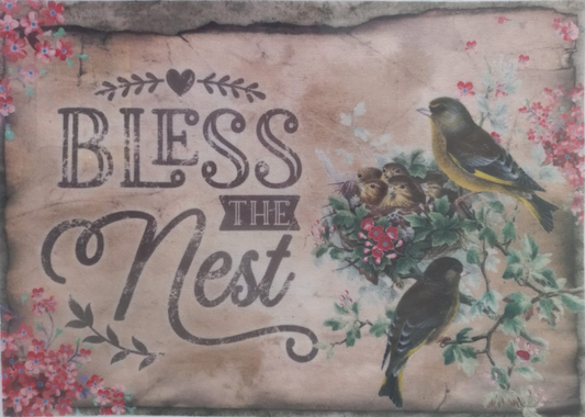 A square decorative sign or print with the phrase “Bless the Nest” in dark script and stencil lettering, surrounded by floral borders and two yellow-and-black birds perched on a nest with eggs. The background is a distressed warm beige/tan tone.