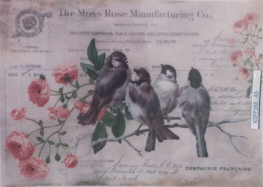 A vintage-style printed textile or craft paper design featuring four birds perched on a branch among pink roses, with printed text including 'The Moss Rose Manufacturing Co.' and 'Compagnie Francaise.