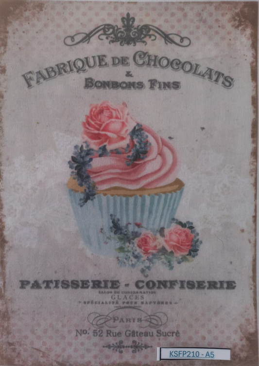 A vintage-style chocolate and pastry label or print featuring an illustrated pink frosted cupcake with roses, surrounded by decorative text including 'Fabrique de Chocolats & Bonbons Fins' and 'Patisserie - Confiserie'. The print is photographed inside a clear plastic sleeve on a white background.