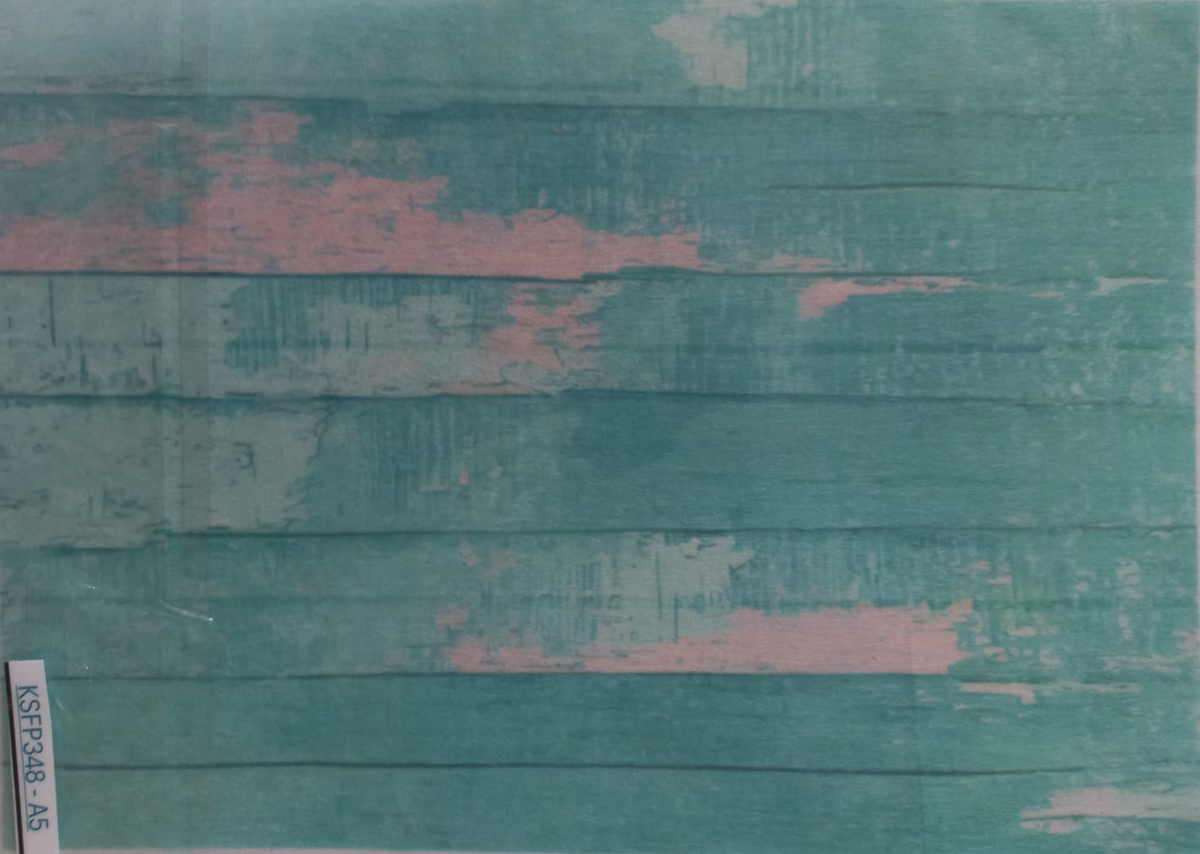 A rectangular printed backdrop or card featuring a distressed teal wood plank pattern with patches of pink and off-white, photographed flat against a light background.