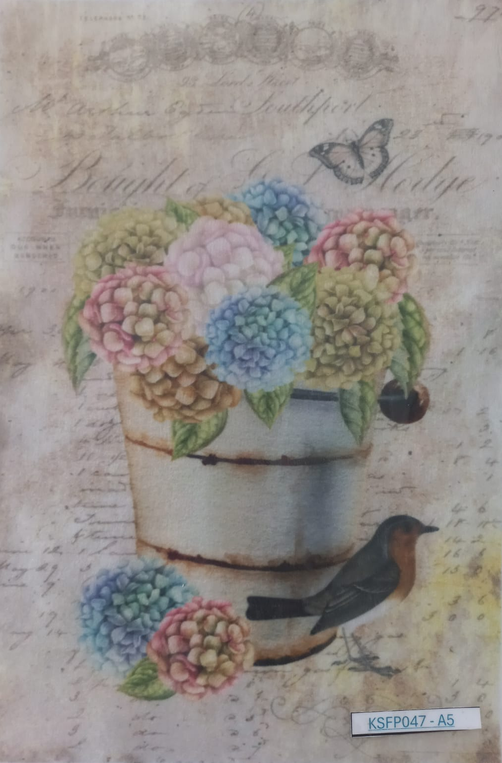 A square decorative paper or card featuring a vintage-style floral design with pastel hydrangeas in a rustic metal pot, a small bird, and cursive script on an aged beige background.