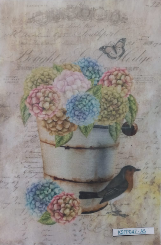 A square decorative paper or card featuring a vintage-style floral design with pastel hydrangeas in a rustic metal pot, a small bird, and cursive script on an aged beige background.