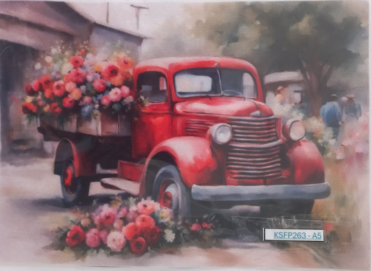 A vintage-style art print depicting a red pickup truck loaded with colorful flowers, set in an outdoor scene with soft-focus trees and figures. The print is photographed on a white surface with a small label reading KSFP263-A5 at the bottom right.