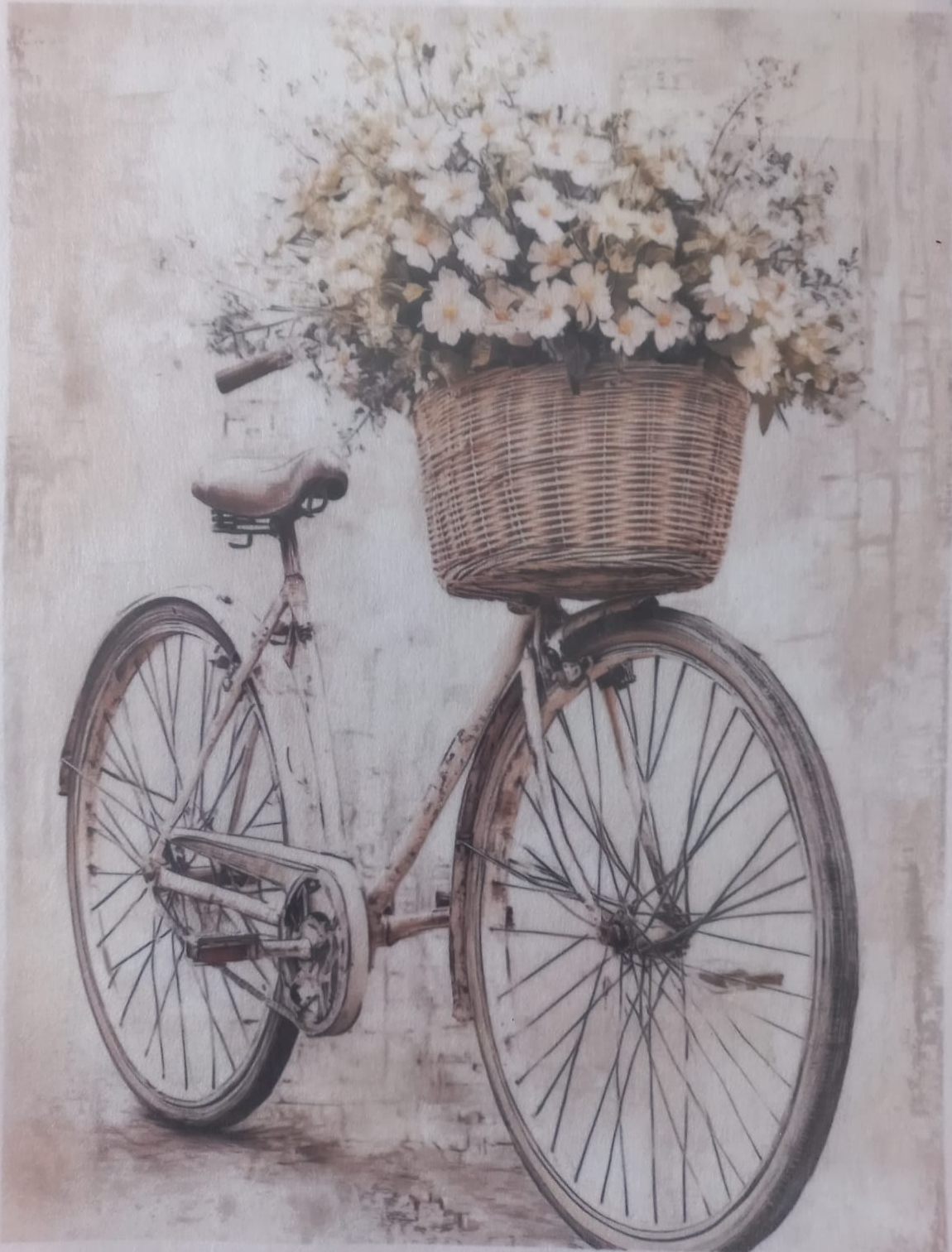 A vintage-style bicycle with a wicker basket overflowing with white flowers, shown against a softly textured cream background. The print has a warm, slightly aged aesthetic with subtle shadows and decorative text along the top and bottom borders.