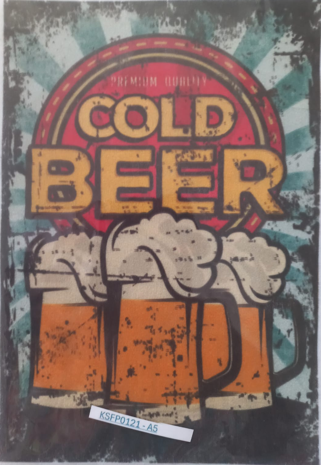 A rectangular printed sign or poster with a distressed retro design reading 'COLD BEER' above three foaming beer mugs. The artwork has teal, red, orange, cream, and black tones, and the sign is photographed against a light gray background with a small label attached near the bottom.