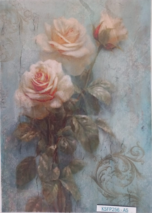 A vintage-style floral art print featuring three cream and pale pink roses with green leaves on a textured light blue background. The print has a distressed, aged aesthetic with a white border and a small label at the bottom right.