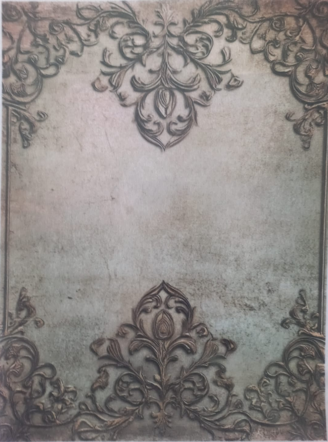 A vintage-style decorative paper or card featuring ornate damask corner flourishes and a distressed aged center, photographed flat against a white background.