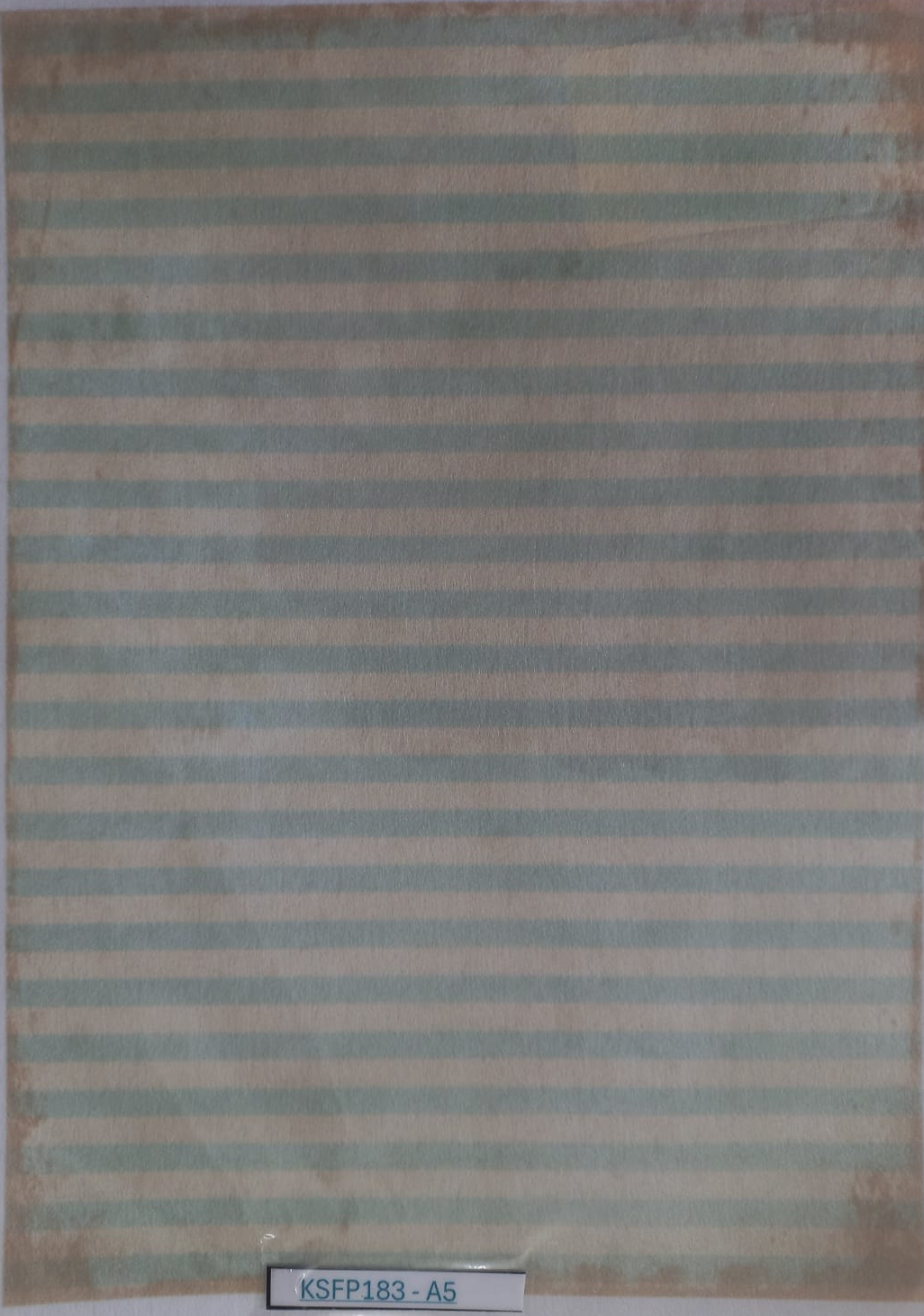 A rectangular striped fabric or paper sample with alternating muted sage green and beige horizontal stripes, photographed flat against a white background. A small label at the bottom reads KSF18183-A5.