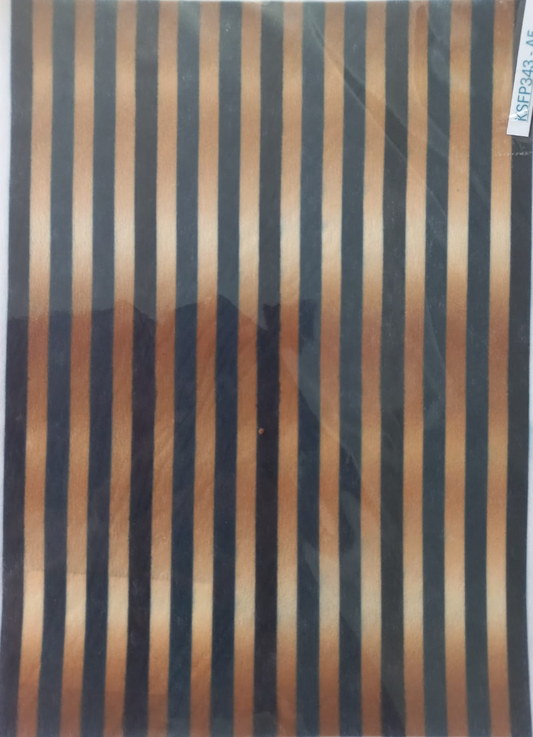 A sheet of patterned fabric or material inside a clear plastic sleeve, featuring vertical stripes in black, dark brown, and beige with a gradient effect.