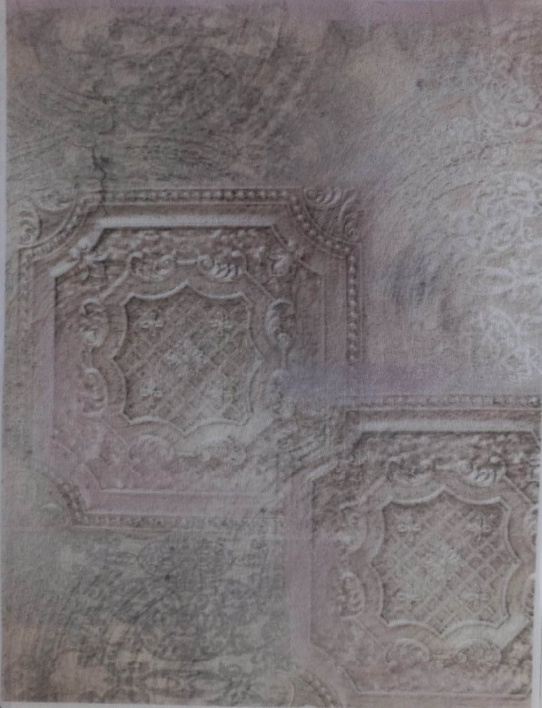 A sheet of vintage-style decorative paper with embossed ornate patterns and distressed textures, displayed flat on a white surface.