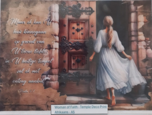 A square temple-style art print in a clear protective sleeve, showing a woman in a white dress standing before an ornate wooden door, with Dutch scripture text on the left. A small label at the bottom reads 'Woman of Faith - Temple Deco Print Afrikaans - A5'.